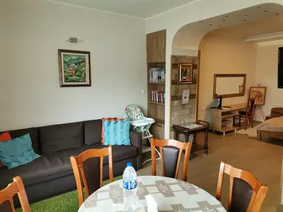 a living room with a couch and a table at Guest Apartment Monarch in Smolyan