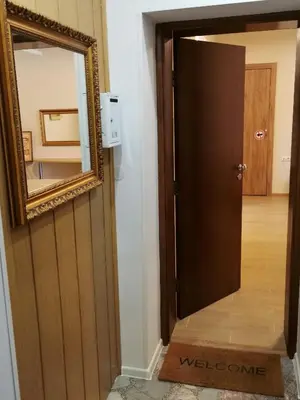 a mirror and a door in a room at Guest Apartment Monarch in Smolyan