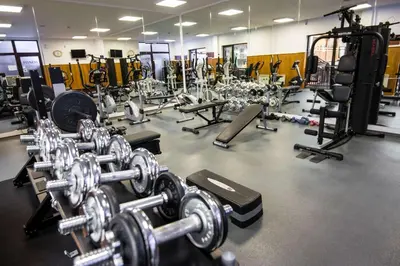 a gym filled with lots of dumbbells and other equipment at The Balkan Jewel Resort, Trademark Collection by Wyndham in Bansko