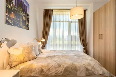 a bedroom with a bed with a large window at The Balkan Jewel Resort, Trademark Collection by Wyndham in Bansko