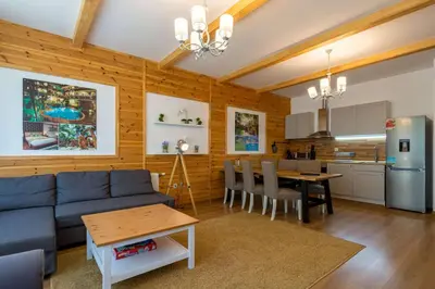 a living room and kitchen with a blue couch and a table at The Balkan Jewel Resort, Trademark Collection by Wyndham in Bansko