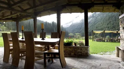 a table and chairs in a pavilion with a view at Family Hotel Arkan Han in Trigrad