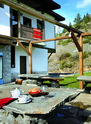 a table with a bowl of food on top of it at Family Hotel Arkan Han in Trigrad
