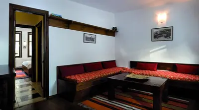 a living room with a couch and a table at Family Hotel Arkan Han in Trigrad