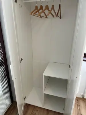 a white walk in closet with hangers at Borovets Gardens Chalet Flat in Borovets
