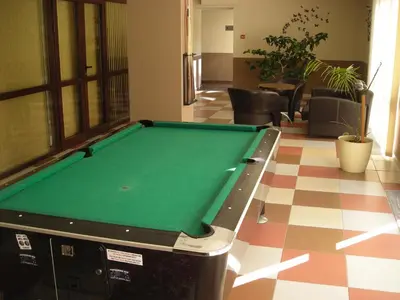 a pool table in the middle of a room at Borovets Gardens Chalet Flat in Borovets