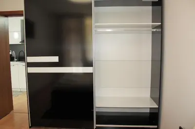 a black and white cabinet in a kitchen at PM Services Sequoia Apartment in Borovets