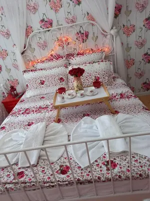 a bedroom with a bed with a table on it at Guesthouse Jasmin in Sapareva Banya