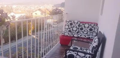 a chair sitting on a balcony with a view at Guesthouse Jasmin in Sapareva Banya