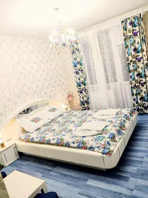 a bedroom with a large bed with flowers on it at Guesthouse Jasmin in Sapareva Banya