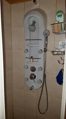 a shower with a rack of shower heads in a bathroom at Chalet Taffski in Borovets
