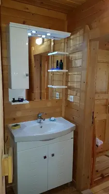 a bathroom with a sink and a mirror at Chalet Taffski in Borovets