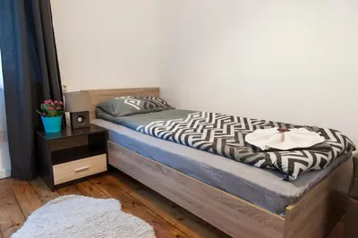 a bedroom with a bed with a zebra blanket and a night stand at Graf Ignatiev - 3BR APART in Sofia