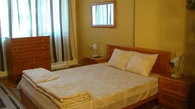 a bedroom with a bed and a dresser and a window at Apartment SOFIA Center in Sofia