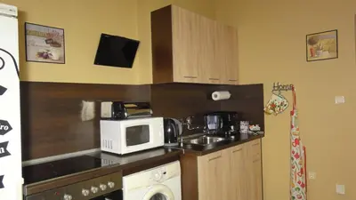 a small kitchen with a microwave and a sink at Apartment SOFIA Center in Sofia
