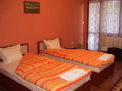two beds sitting next to each other in a room at Kestenite Family Hotel in Samokov