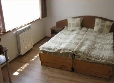 a bedroom with a bed in a room with a window at The Castle Hotel in Samokov