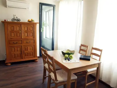 a dining room table with a bowl of fruit on it at Apartments Sofia Yavorov in Sofia