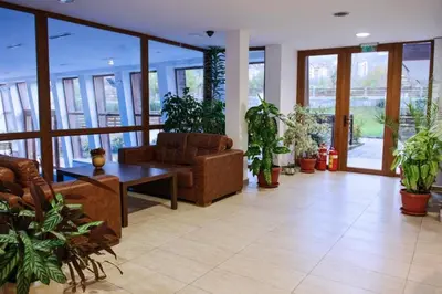 a living room filled with furniture and potted plants at Mountain View Resort Studio in Bansko