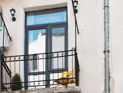 a window on a building with a balcony at Mouse House Kapana in Plovdiv