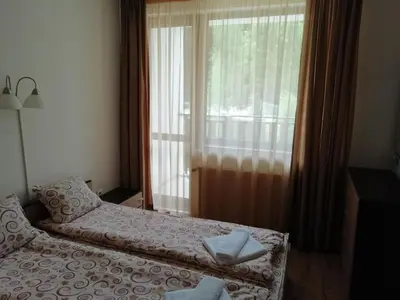 a bedroom with a bed and a large window at Apartment in Borovets Gardens C17 in Borovets