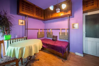a room with a table and a purple wall at Sunny Apartment Sofia in Sofia