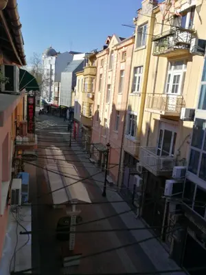 an empty street in a city with buildings at Vacation Apartment in Plovdiv