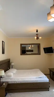 a bedroom with a bed and a mirror at Grand Monastery Private Apartments in Pamporovo