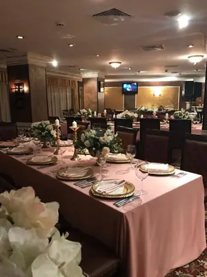 a dining room with a long table with wine glasses at Grand Monastery Private Apartments in Pamporovo