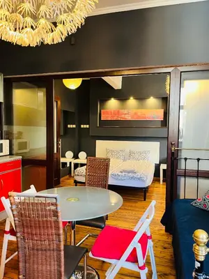 a living room with a table and chairs and a couch at Lovely place in Sofia