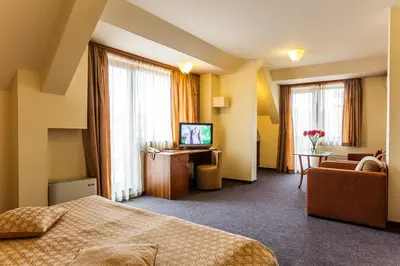 a hotel room with a bed and a television at Sofia Place Hotel by HMG in Sofia