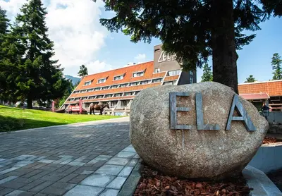 a large rock with the word eat on it in front of a building at Park Hotel Ela in Borovets