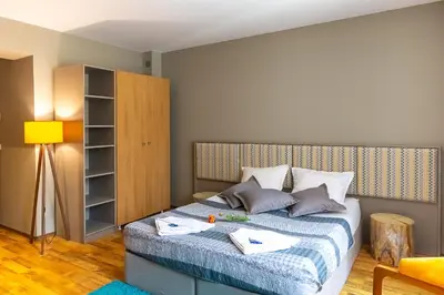 a bedroom with a bed and a book shelf at Sunny Hills Ski&Wellness in Pamporovo