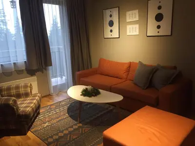 a living room with a couch and a table at Sunny Hills Ski&Wellness in Pamporovo