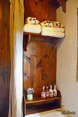 a wooden shelf with two beds on top of it at Kalinia Guesthouse B&B in Kovachevitsa