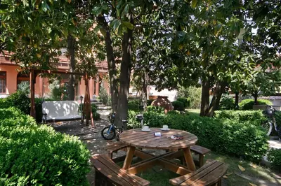 a wooden table and two chairs under a tree at Anita House in Perushtitsa
