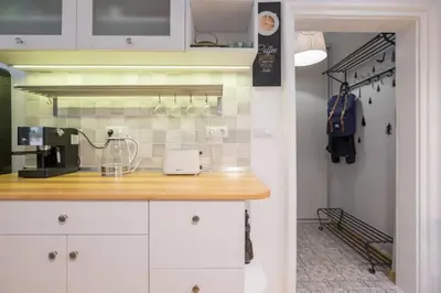 a kitchen with white cabinets and a counter top at Downtown Wanderlust Apartment in Sofia