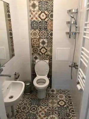 a bathroom with a toilet and a sink at Downtown Wanderlust Apartment in Sofia