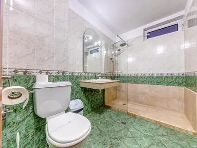 a bathroom with a toilet and a sink and a shower at Hotel Elit in Devin