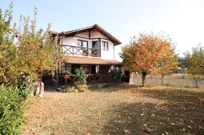 a large house with trees in front of it at Belcheva kashta in Banya