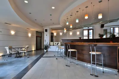 a bar in a restaurant with chairs and tables at Bellevue Residence Apartments in Bansko