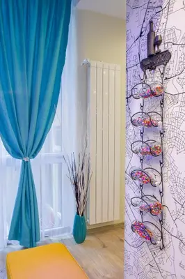 a room with a blue curtain and a window at City center Apartment in Sofia