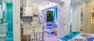 a bathroom with purple furniture and a dining room at City center Apartment in Sofia