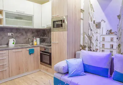 a kitchen with a purple couch in a room at City center Apartment in Sofia