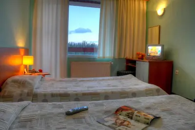a hotel room with two beds and a television at Hotel Prespa in Pamporovo