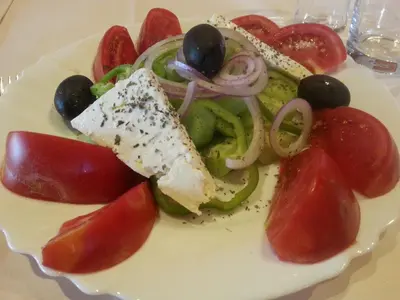 a plate of food with a salad on a table at Hotel Galant in Sofia
