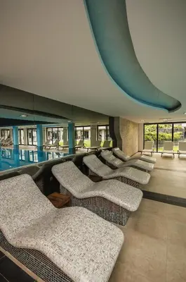 a waiting room with a row of chairs and tables at Saint George Palace Aparthotel in Bansko