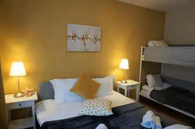 a bedroom with two beds and a bunk bed at Pirin River Ski, Fun and Family in Bansko