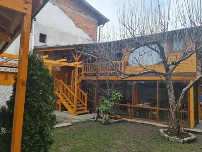 a house with a wooden staircase in front of it at Mamin Kolio in Bansko