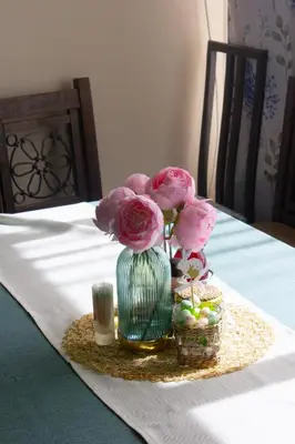 a vase with pink flowers sitting on a table at Meteor Family Hotel in Chepelare